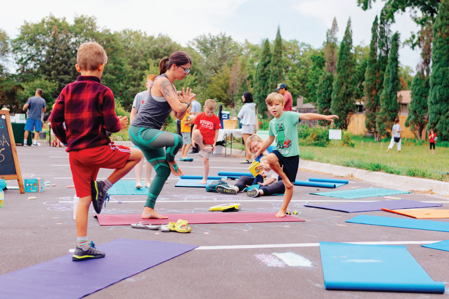 Kids and Adults doing yoga at Garden Party